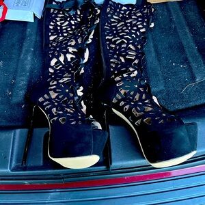 Brand new never worn knee high heels they zip up in back and have a lace bow.